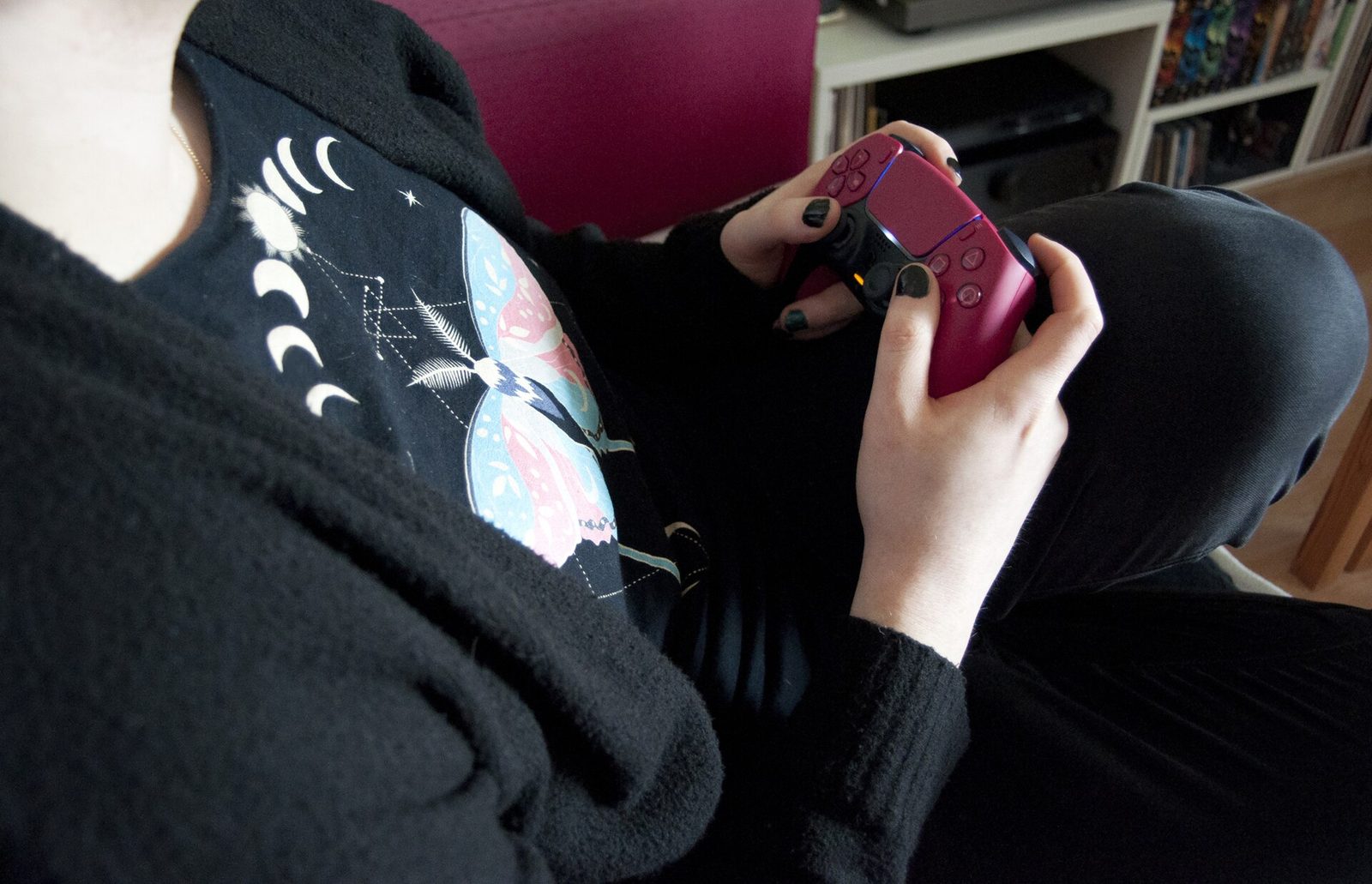 A person at home holding a game controller
